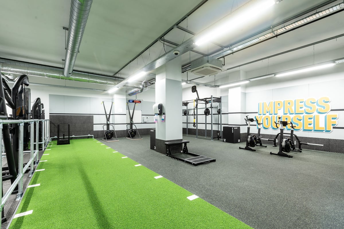 PureGym London Crouch End: Resistance machines, green turf area, weight racks, rubberized flooring.