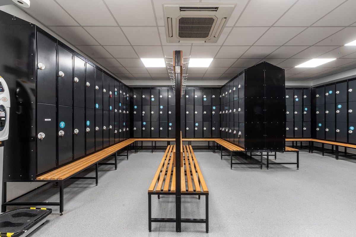 PureGym Coventry Warwickshire Shopping Park: changing room with rows of lockers and benches.