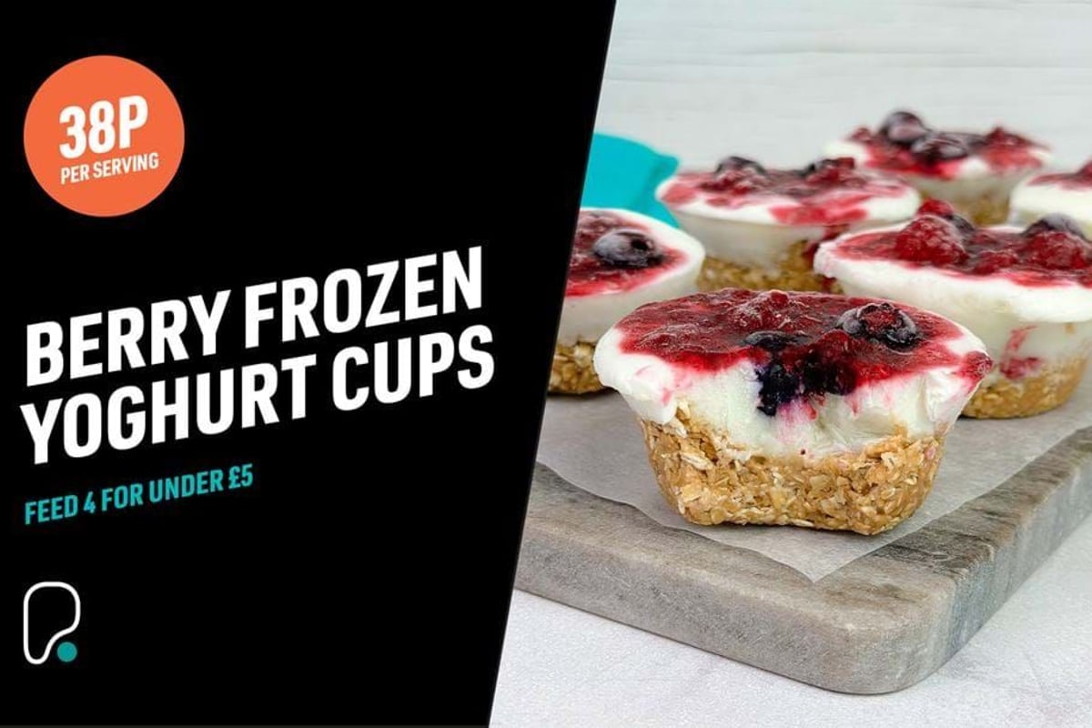 Berry frozen yoghurt cups with granola base and mixed berry topping on a tray