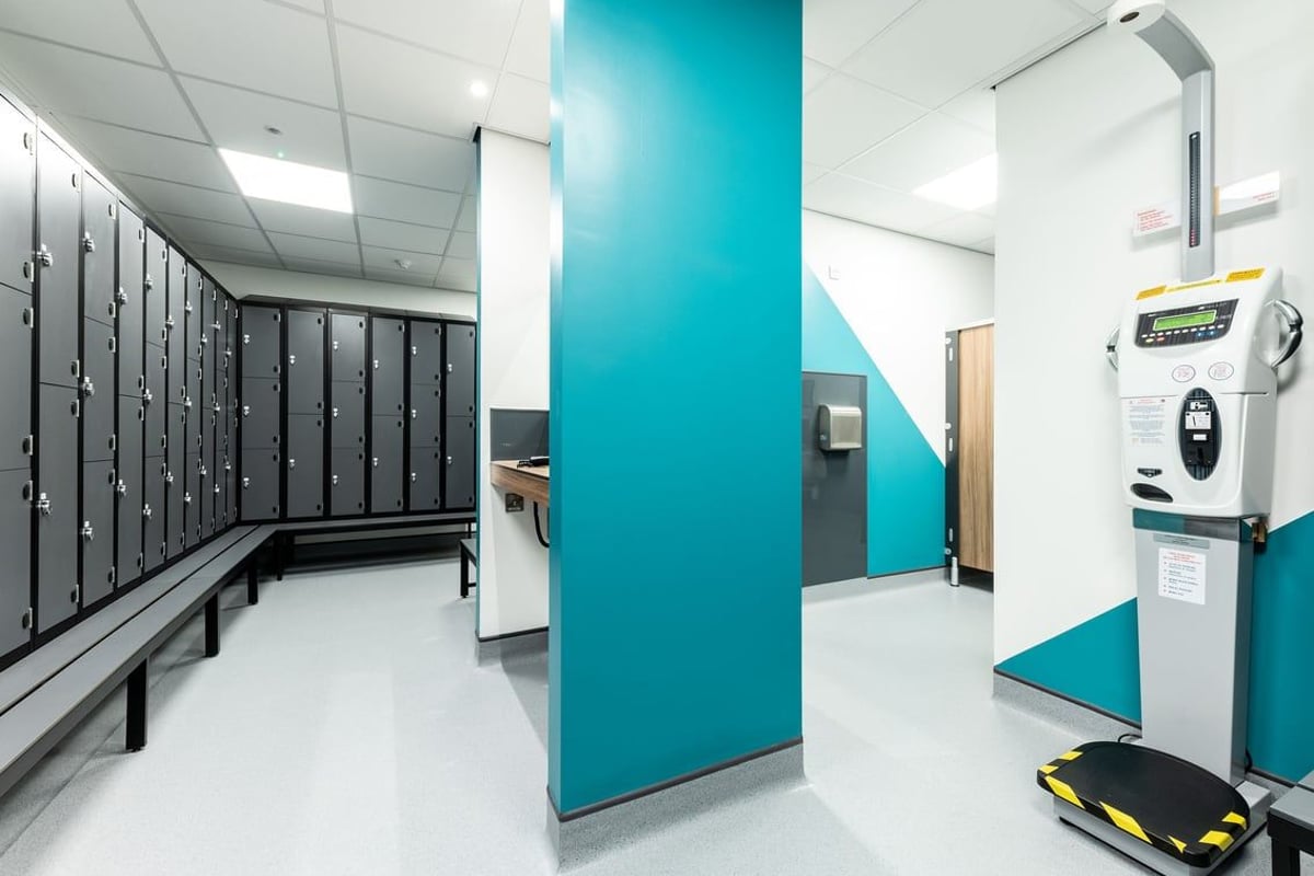 PureGym Great Yarmouth: Lockers, changing cubicles, and vending machine in a gym's communal area.