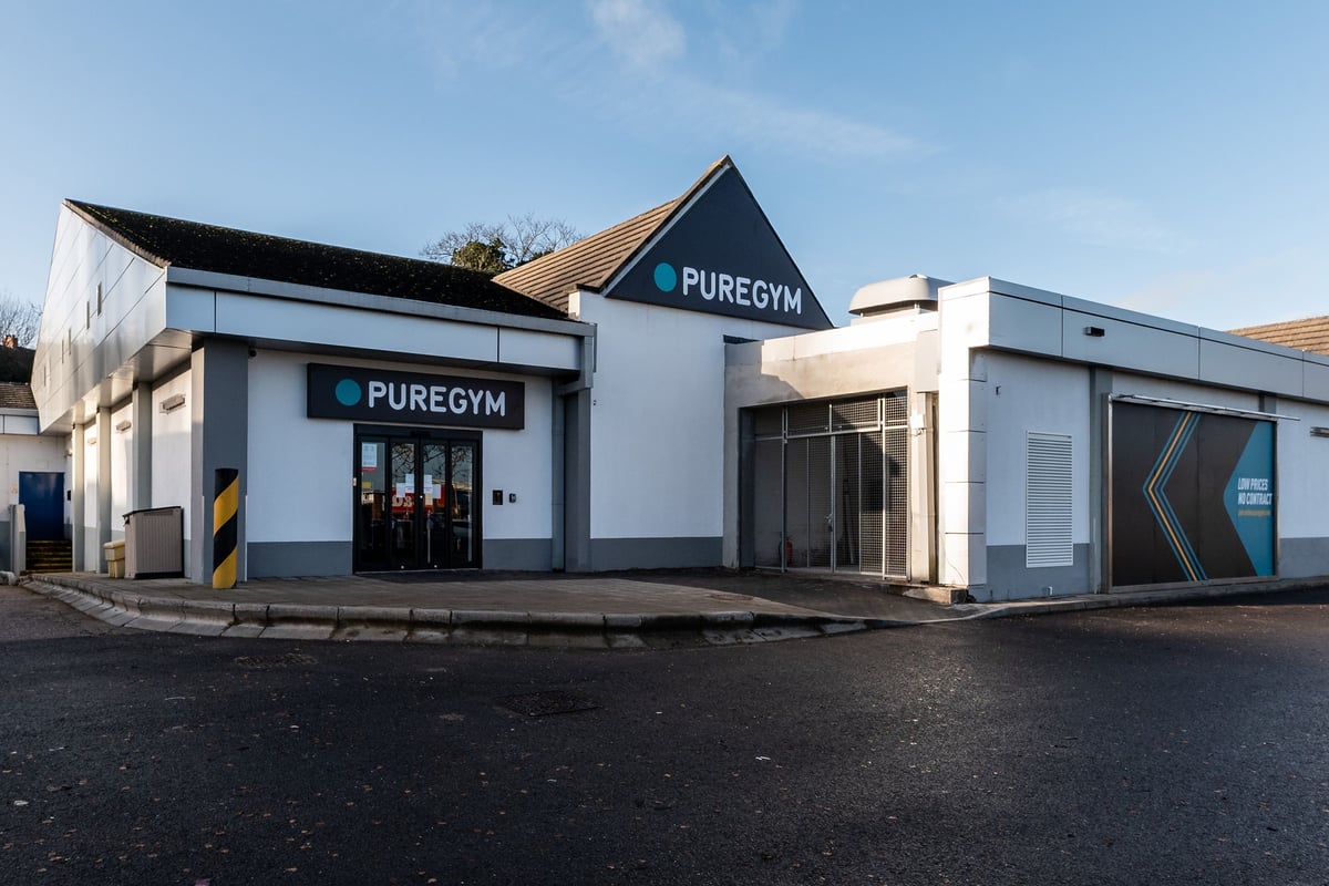 PureGym Uttoxeter: Fitness facility exterior with large windows showcasing equipment inside.