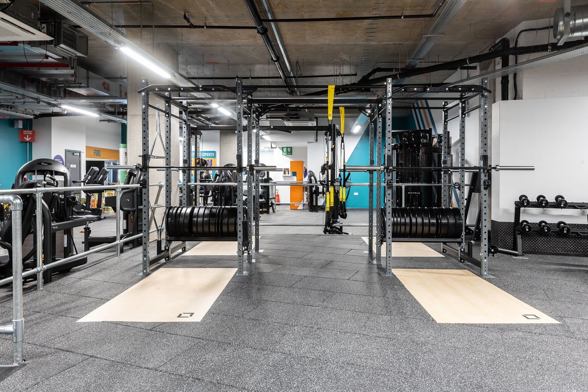PureGym London Hoxton: Racks of kettlebells, barbells, weight plates, rubberised flooring in a warehouse-style gym.