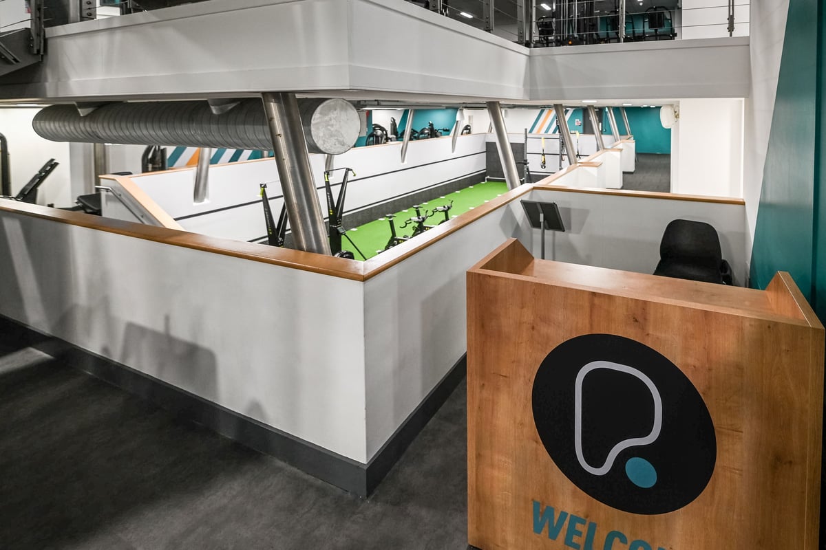 PureGym London Piccadilly: Functional training area with tubing equipment, rubberized flooring, and welcome kiosk.