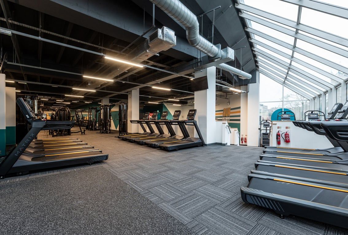 PureGym Ipswich Buttermarket: Rows of treadmills, stairmasters, and exercise equipment in a modern gym interior.
