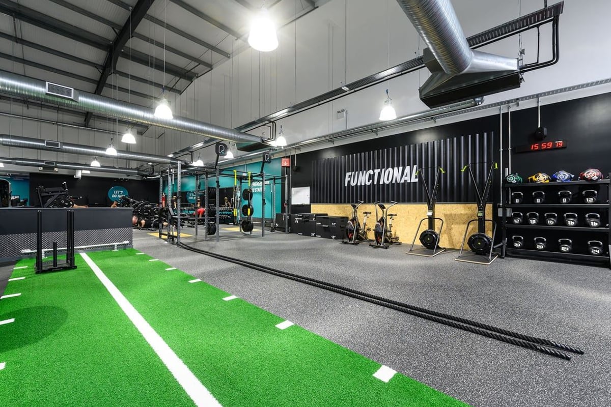 PureGym Bromsgrove Retail Park: Gym with functional training area, turf, free weights, rigs, and weightlifting platforms.