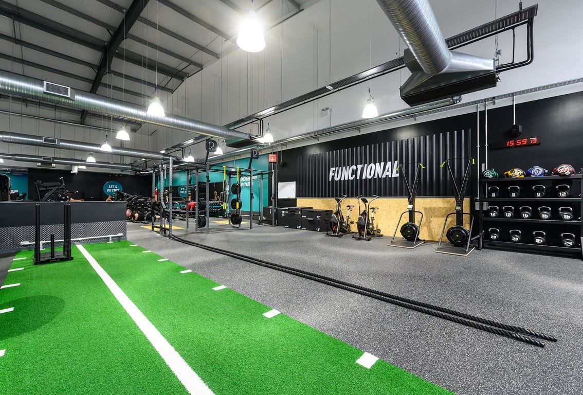PureGym Bromsgrove Retail Park: Gym with functional training area, turf, free weights, rigs, and weightlifting platforms.