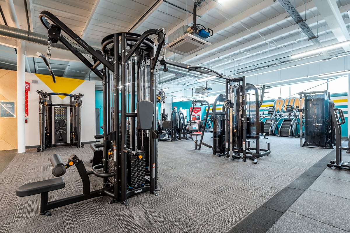 PureGym Bideford: Weights racks, cable machines, benches, rubberized flooring in a spacious, well-equipped gym.