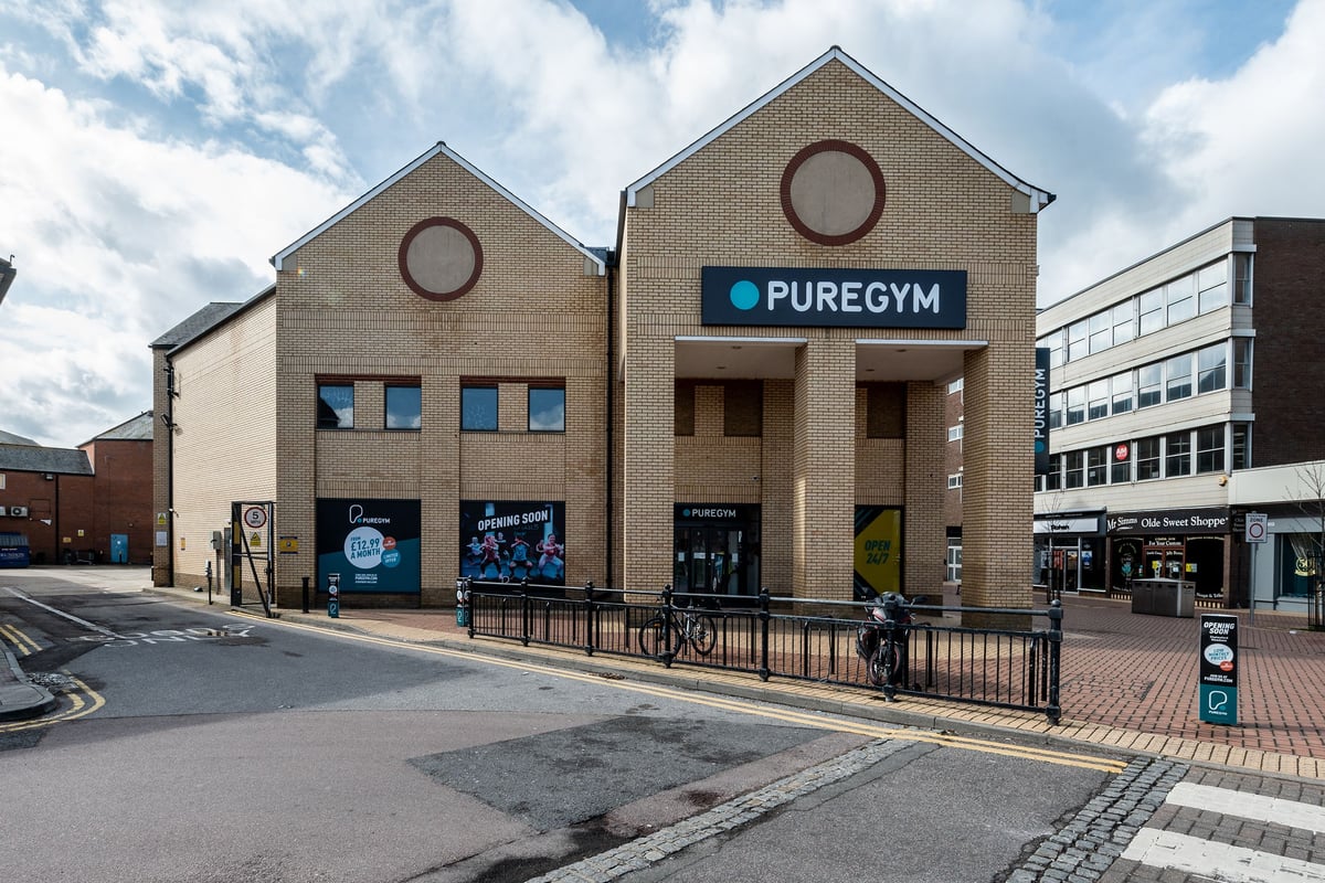 PureGym Chelmsford Meadows: Brick building exterior with 'PUREGYM' signage and cycle stands.