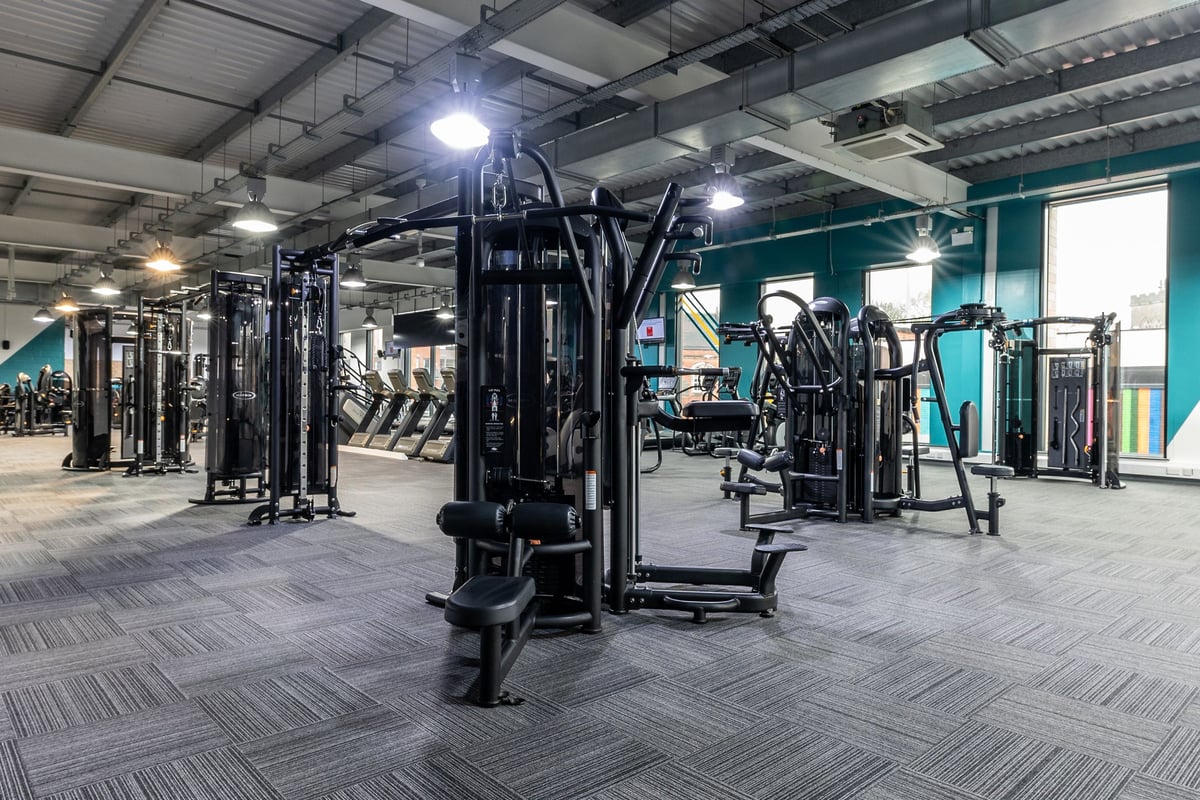 PureGym Nottingham Beeston: Resistance machines, plate-loaded stations, rubberized flooring in a well-lit gym facility.