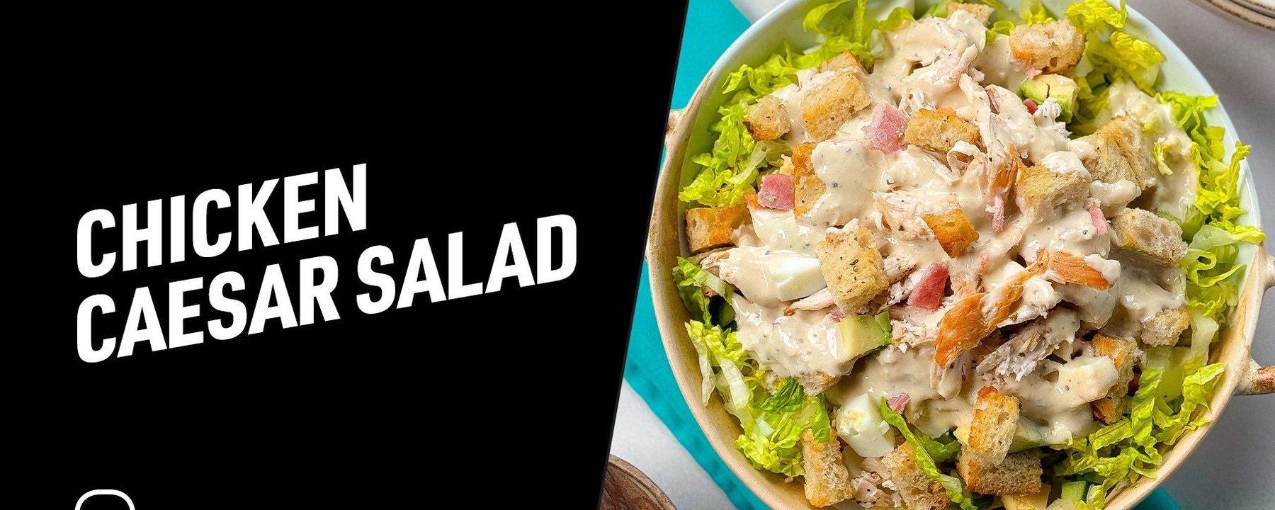 Chicken Caesar salad with lettuce, croutons, chicken pieces, and creamy dressing in bowl