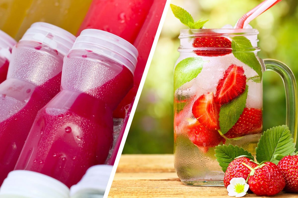 Bottles of red juice on ice and a jar of iced strawberry and mint water