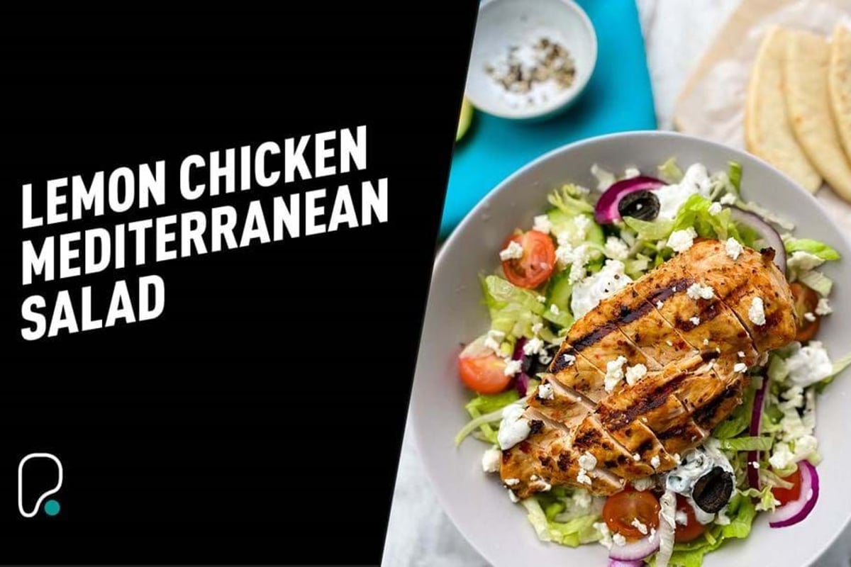 Grilled lemon chicken breast on Mediterranean salad with feta, olives, and tomatoes