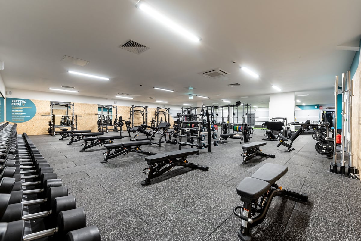 PureGym Tyldesley: Weight machines, benches, dumbbells, and weight racks in a well-equipped gym space.