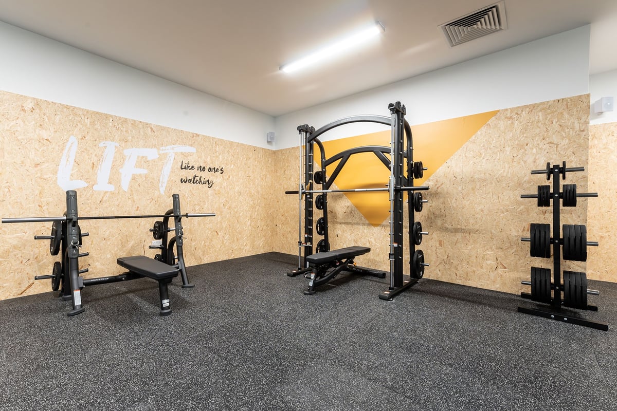 PureGym Knaesborough: Weight racks, cable machines, free weights, benches, and rubberized flooring in a gym studio.