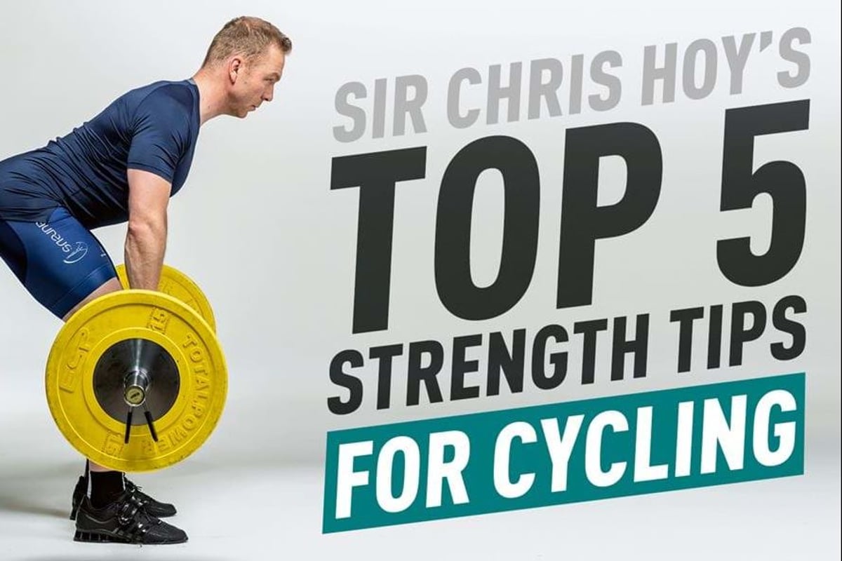 Man in cycling gear lifting a barbell with yellow weights against white background