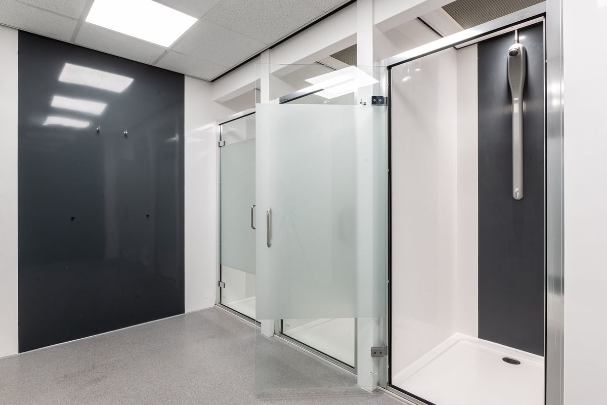 PureGym Coventry Warwickshire Shopping Park: Shower and changing rooms with glass doors and stalls.