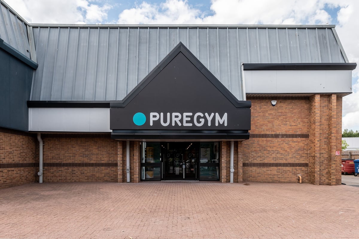 PureGym Northallerton: Gym entrance with brick facade, signage reading "PureGym", and paved parking area.