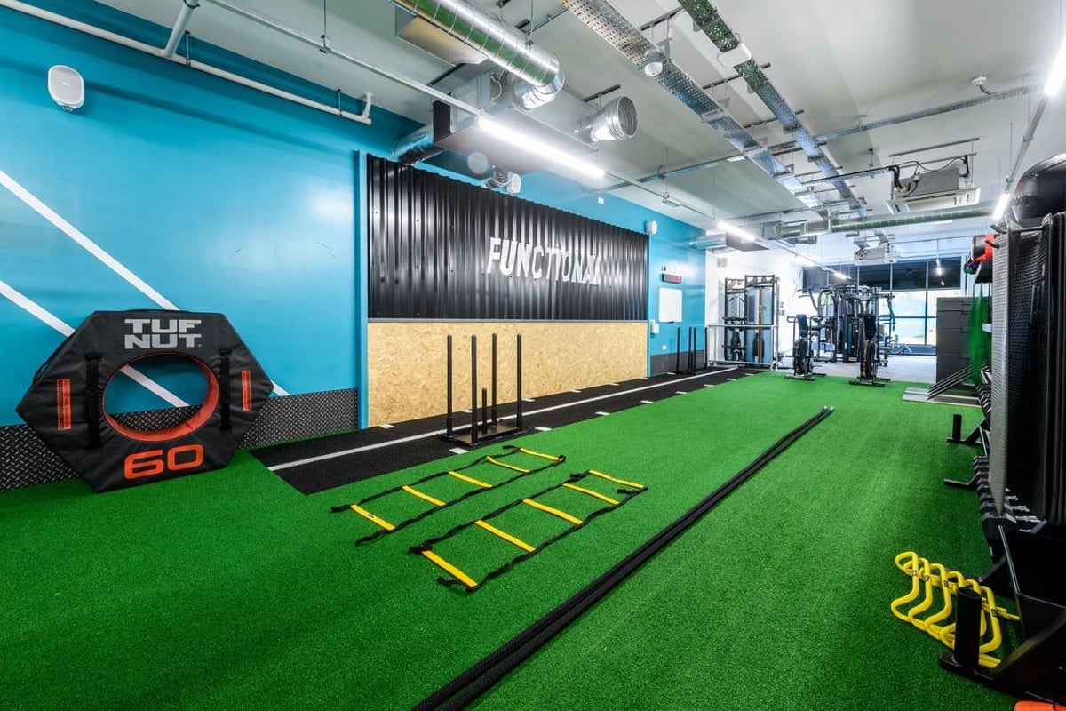PureGym Hereford: Green turf area, agility ladders, punching bags, free weights, resistance bands, and weight machines.