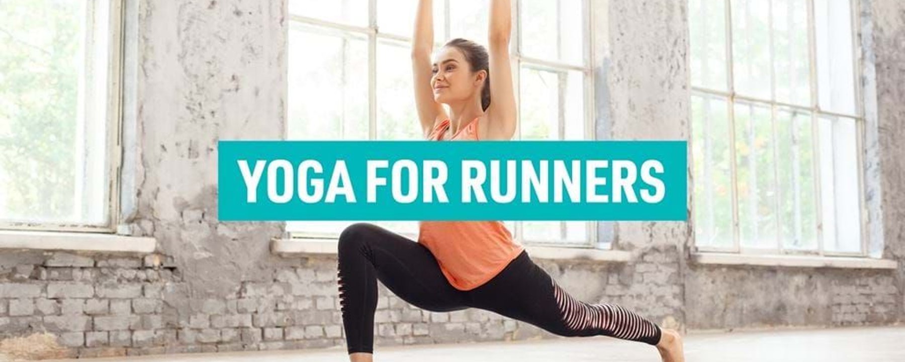 Woman in orange top and black leggings doing yoga lunge pose indoors