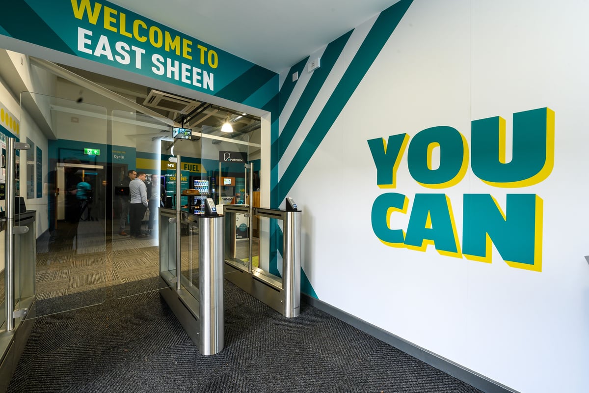 PureGym London East Sheen: Welcome signage and entry gates with motivational text "YOU CAN" displayed prominently.