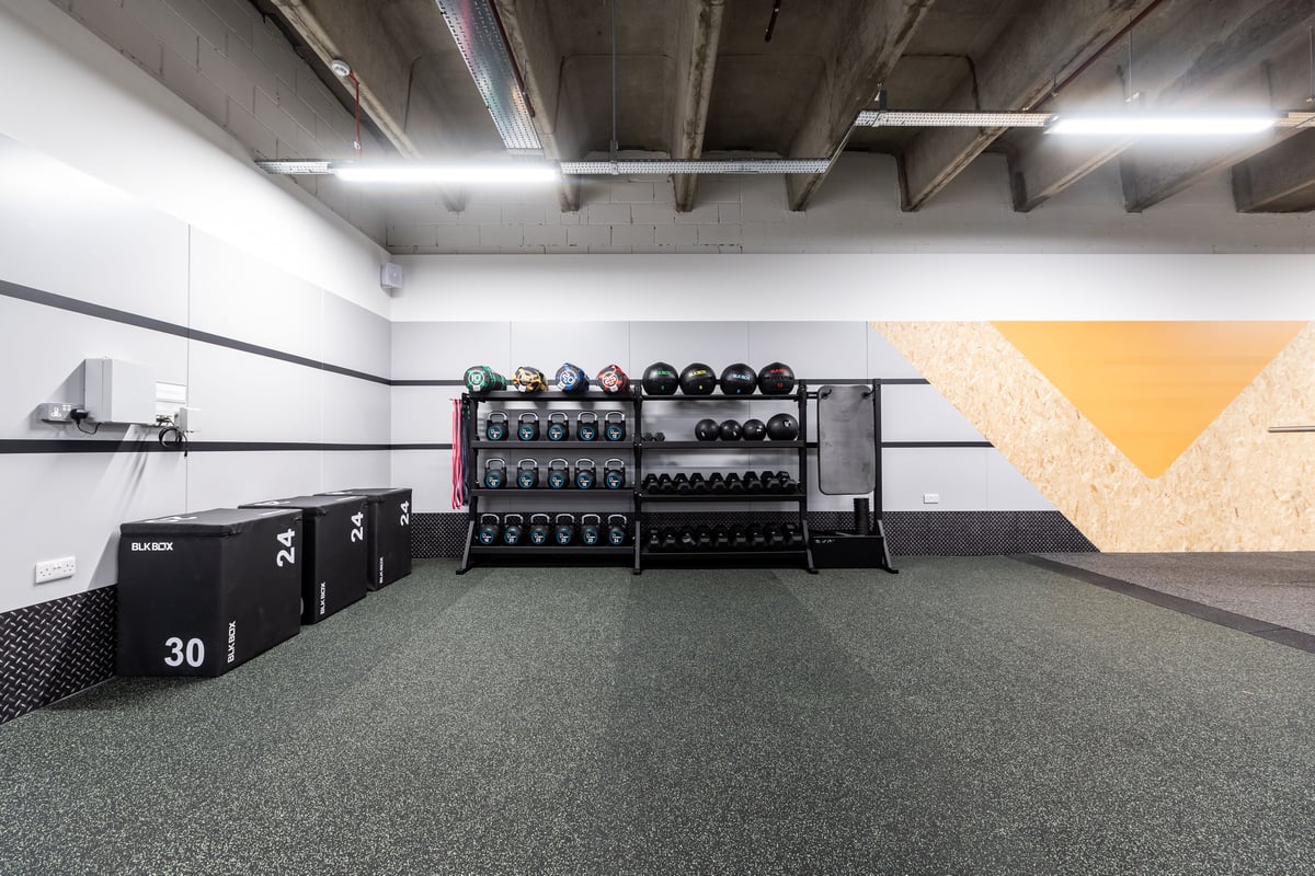 PureGym London Ealing Broadway: Rows of resistance machines, free weights racks, rubberized flooring in a basement gym space.