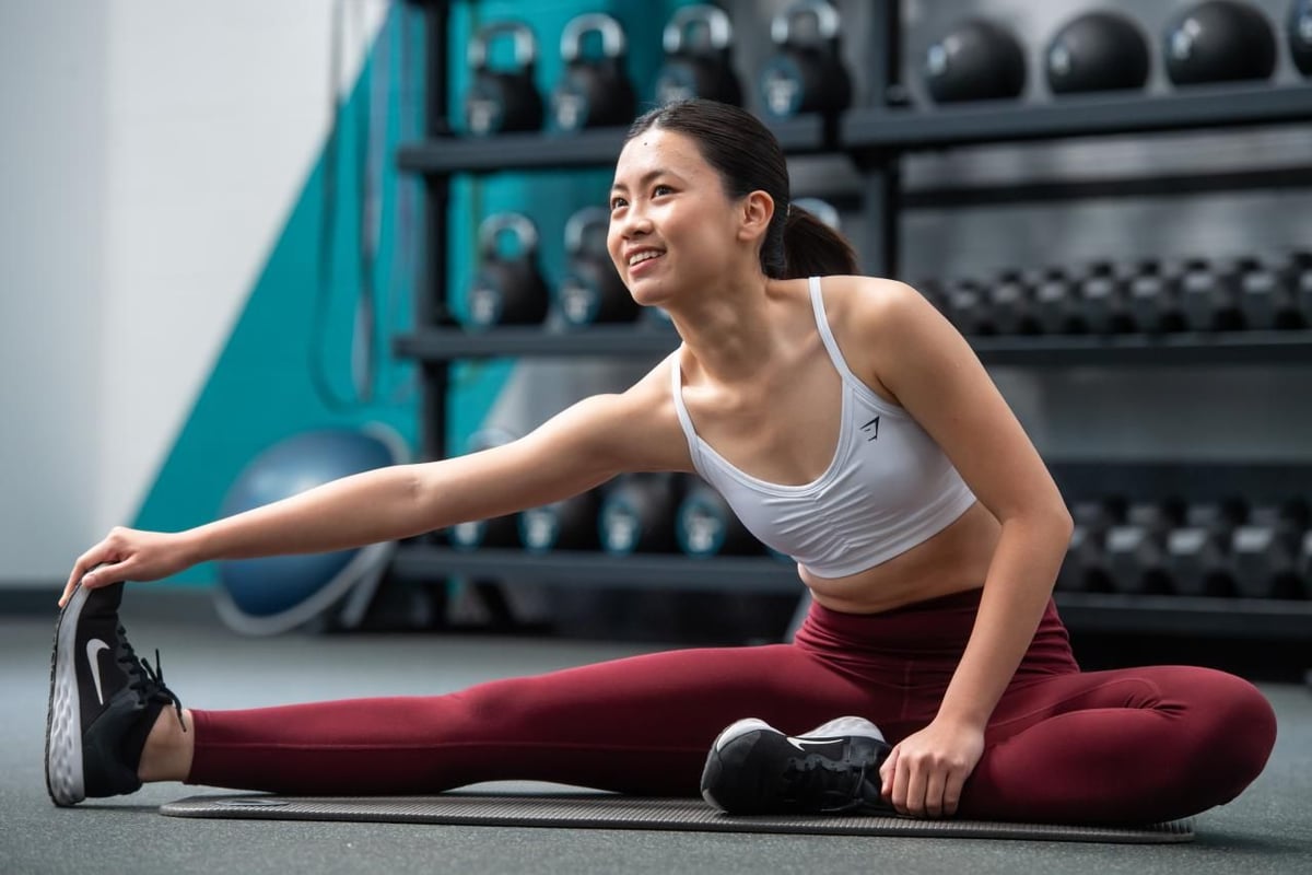 PureGym member stretching her leg