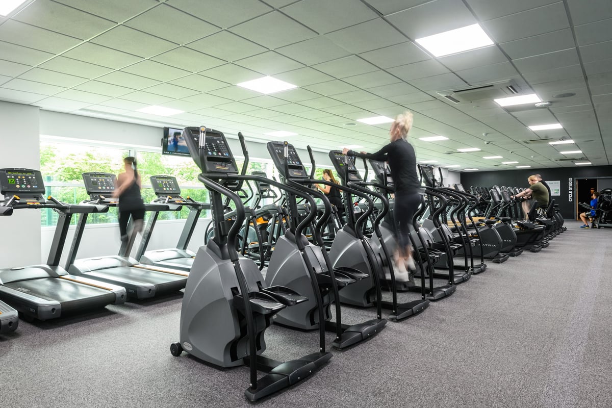 PureGym Newcastle Longbenton: Rows of treadmills and other cardio machines lined up in a brightly lit gym.