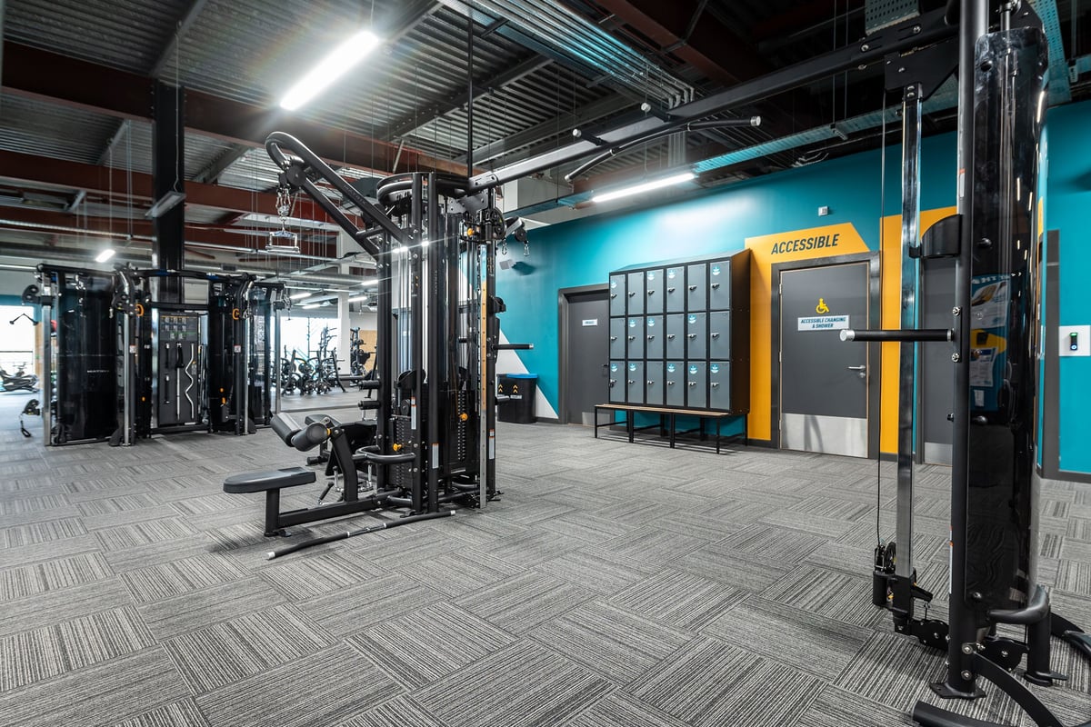 PureGym Craigavon: Weight machines, resistance equipment, benches, and rubberized flooring in a fitness studio.