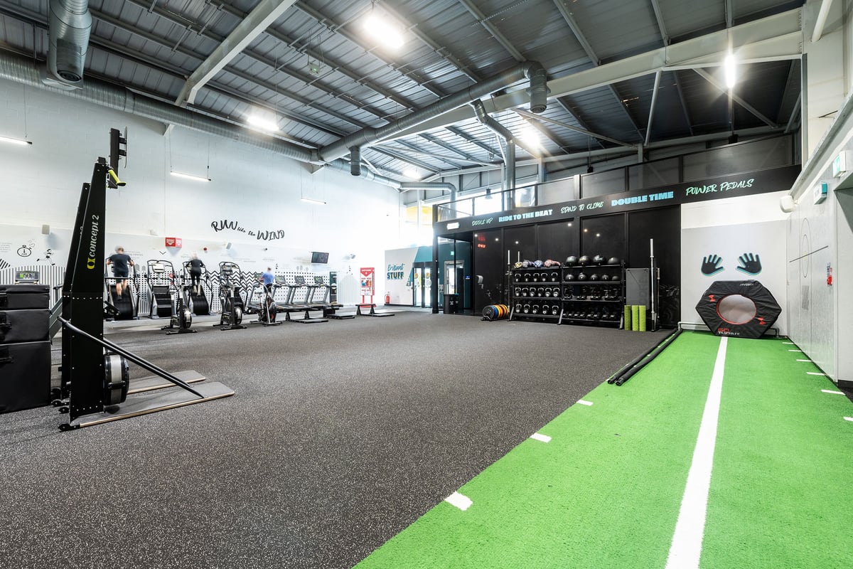 PureGym Southampton Central: Weight racks, lifting platforms, green turf area, rubberised flooring, and wall branding.