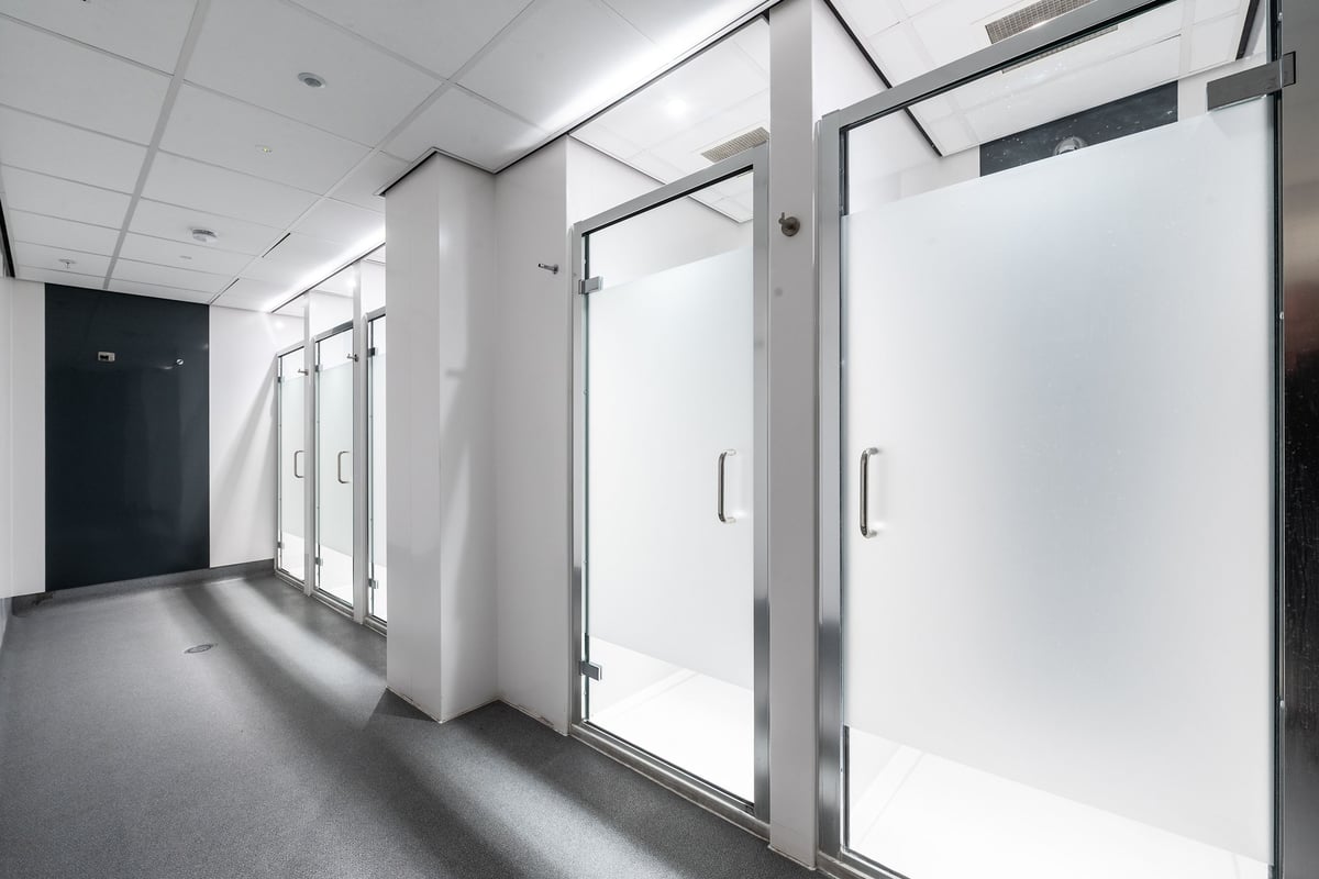 PureGym London Swiss Cottage: Hallway with glass-paneled doors and neutral tones, typical of commercial interiors.