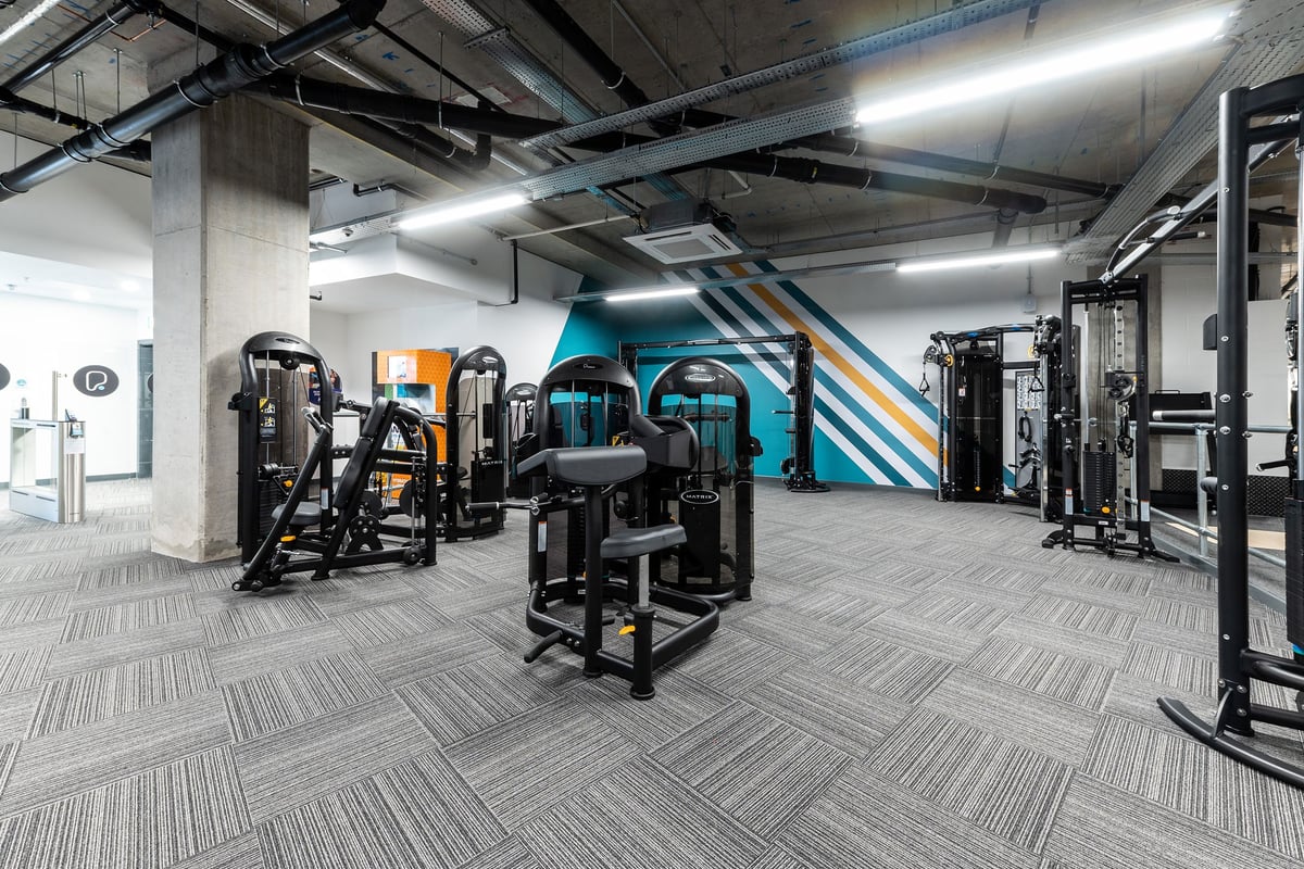 PureGym London Hoxton: Resistance machines, cable crossovers, benches, mirrored wall, industrial-style gym interior.