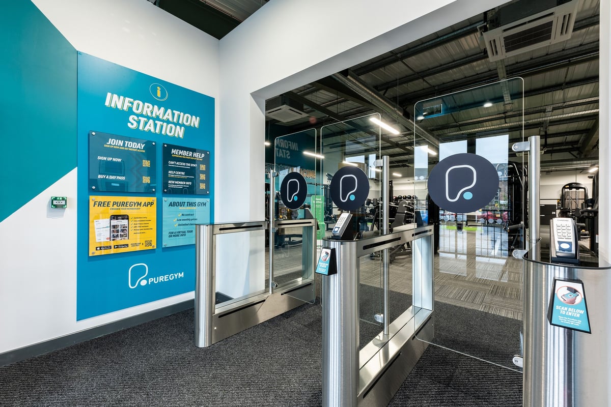 PureGym Alloa: Information station with self-service kiosks and wayfinding signage.
