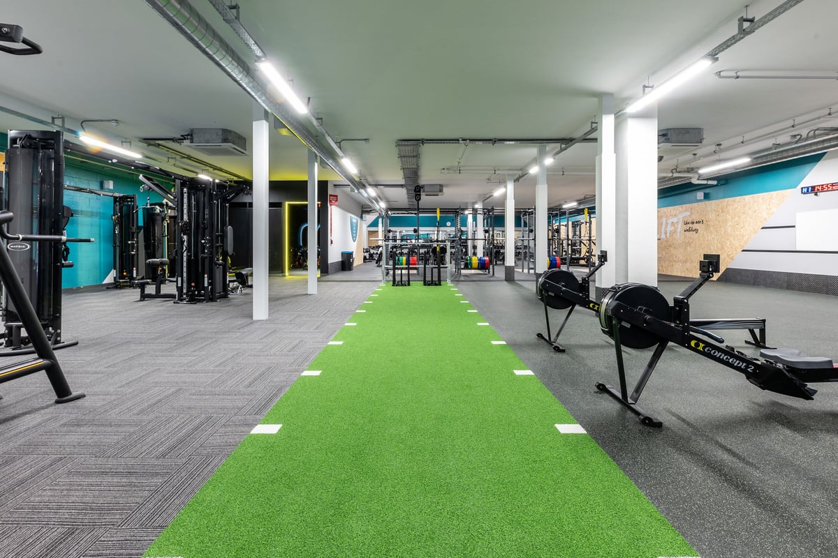 PureGym Redditch Ringway: Weight racks, resistance machines, green turf area, and free weights in a colourful gym space.