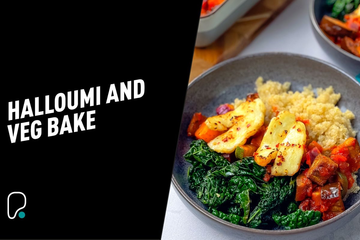 Grilled halloumi, sautéed kale, ratatouille, and quinoa in a grey bowl.