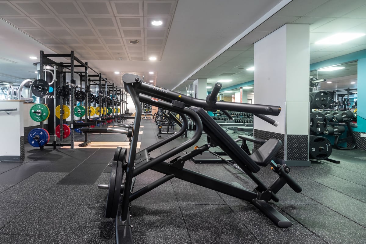 PureGym Edinburgh Exchange Crescent: Weight benches, squat racks, dumbbells, weight plates in a gym floor setting.