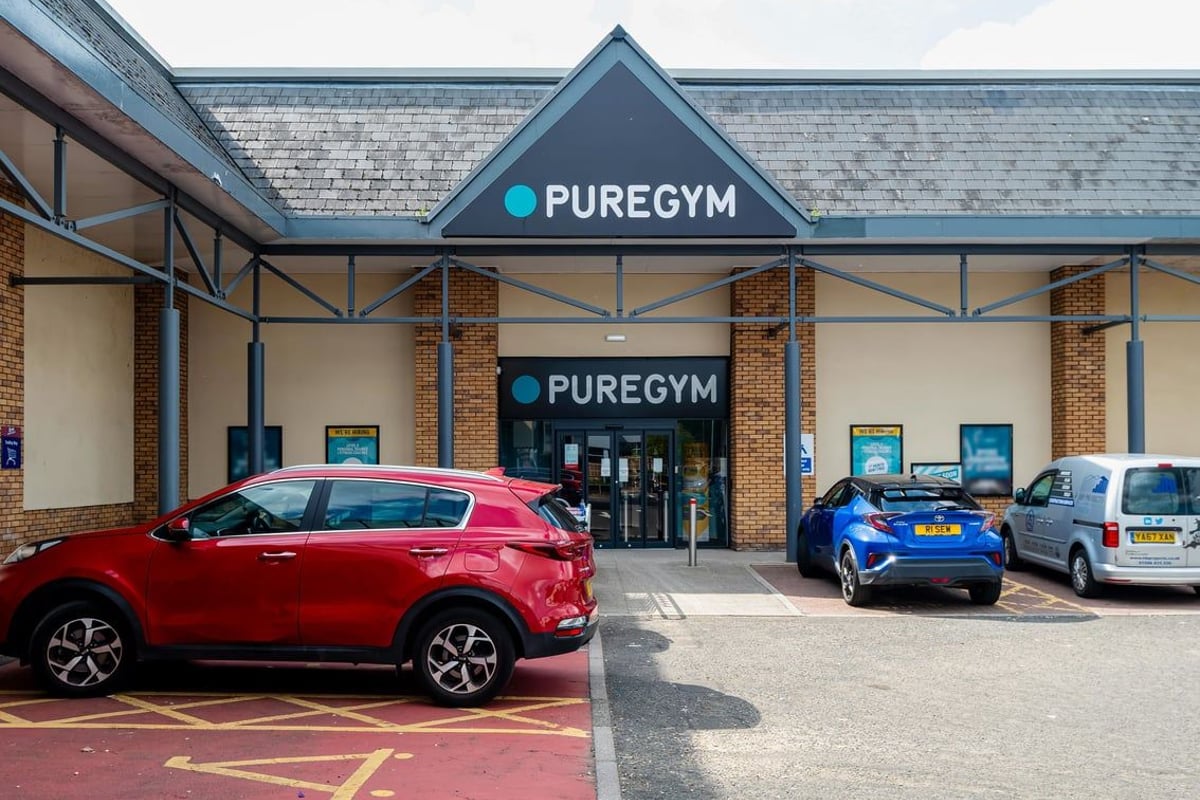 PureGym Linlithgow: Gym exterior with branded signage, parking spaces, and cars outside.