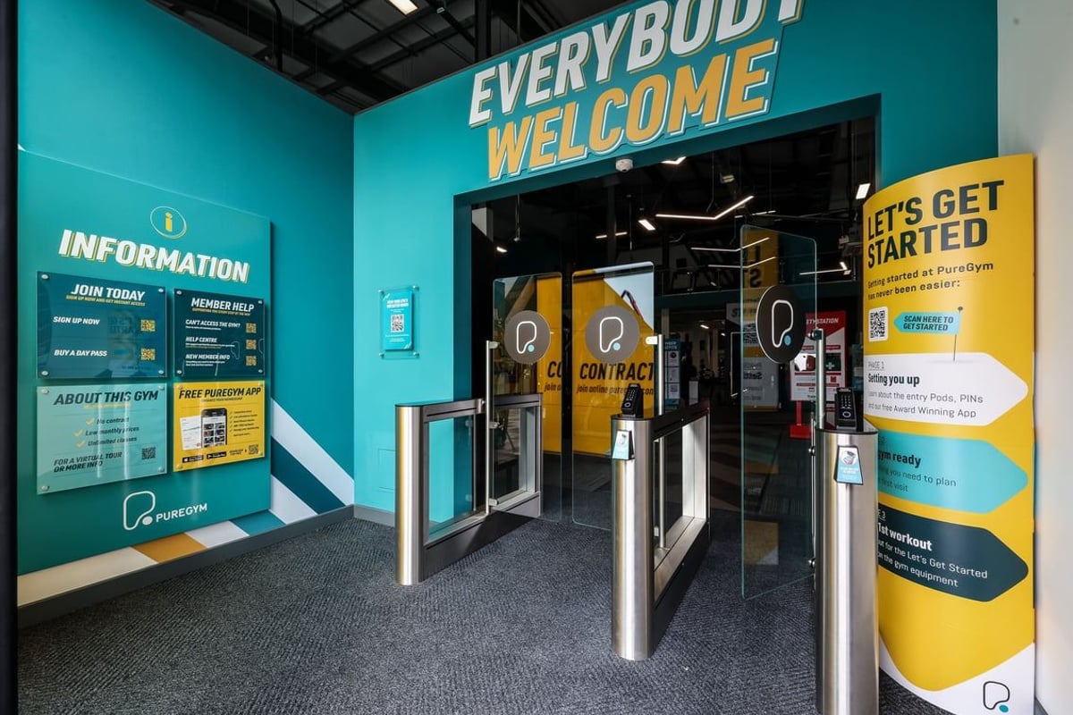 PureGym Bishop Auckland: Entrance lobby with information desk, turnstiles, signage welcoming all.