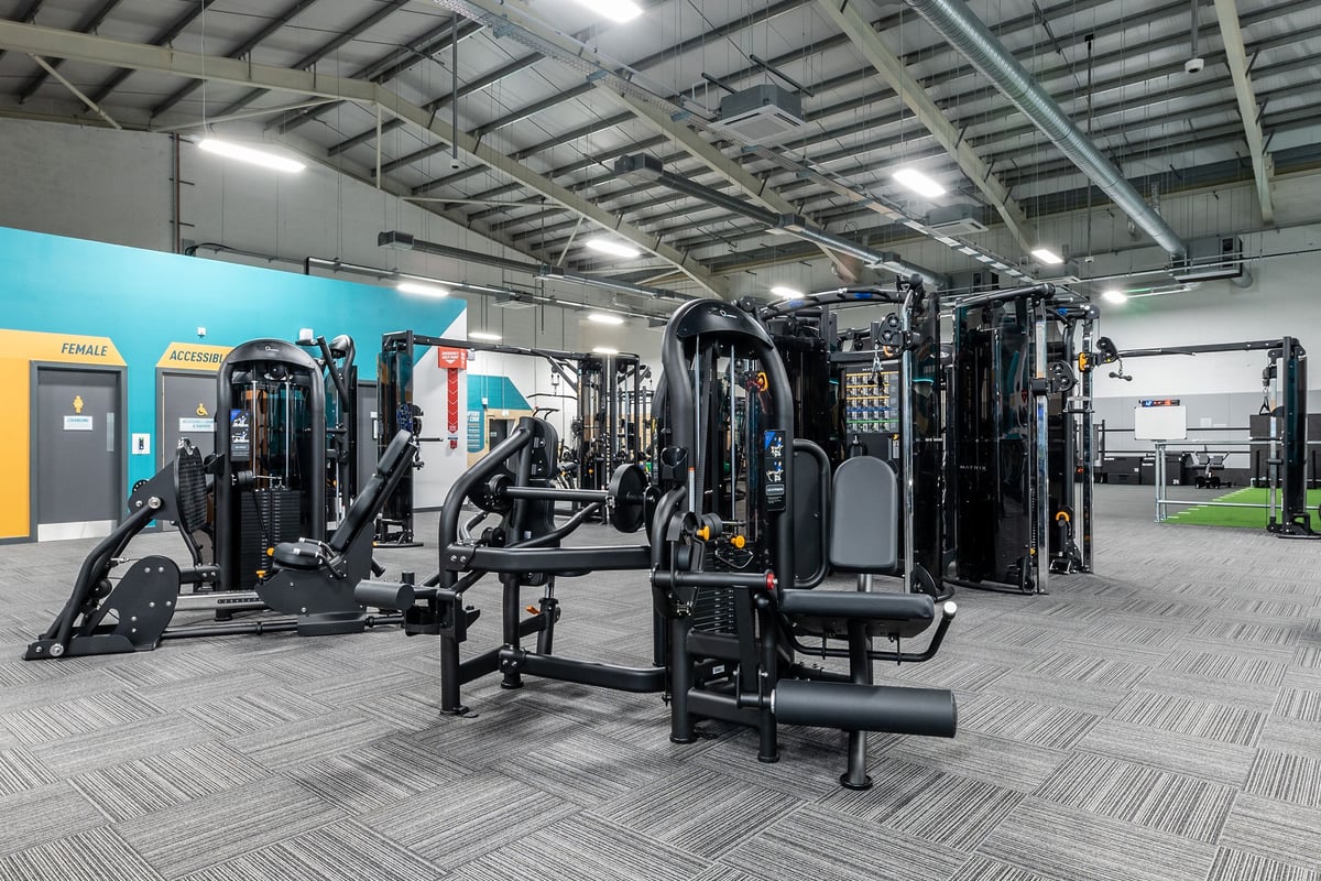 PureGym Lincoln Carlton Centre: Freeweight machines, resistance equipment, benches, and rubberized flooring in a gym setting.