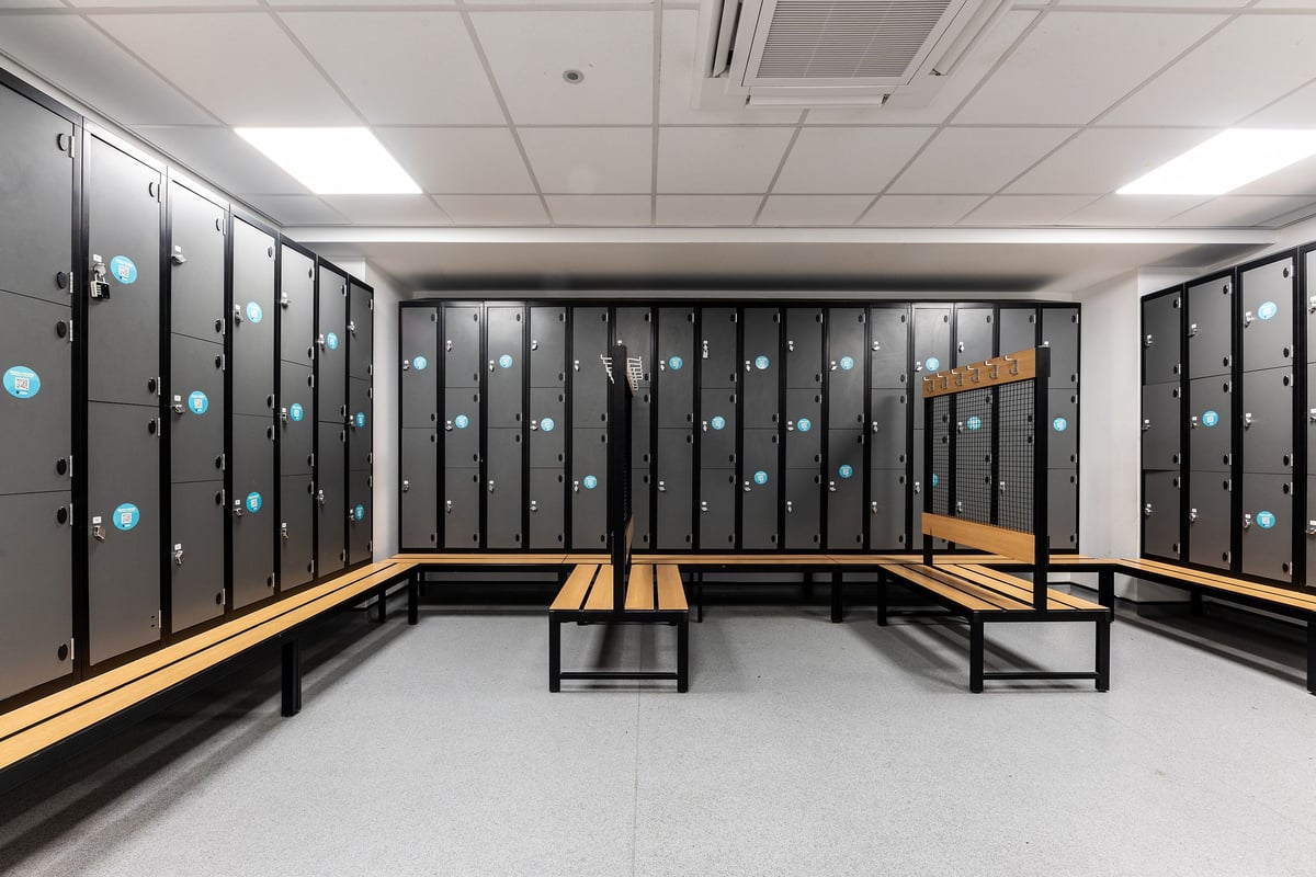 PureGym Leamington Spa: changing room with rows of lockers and benches