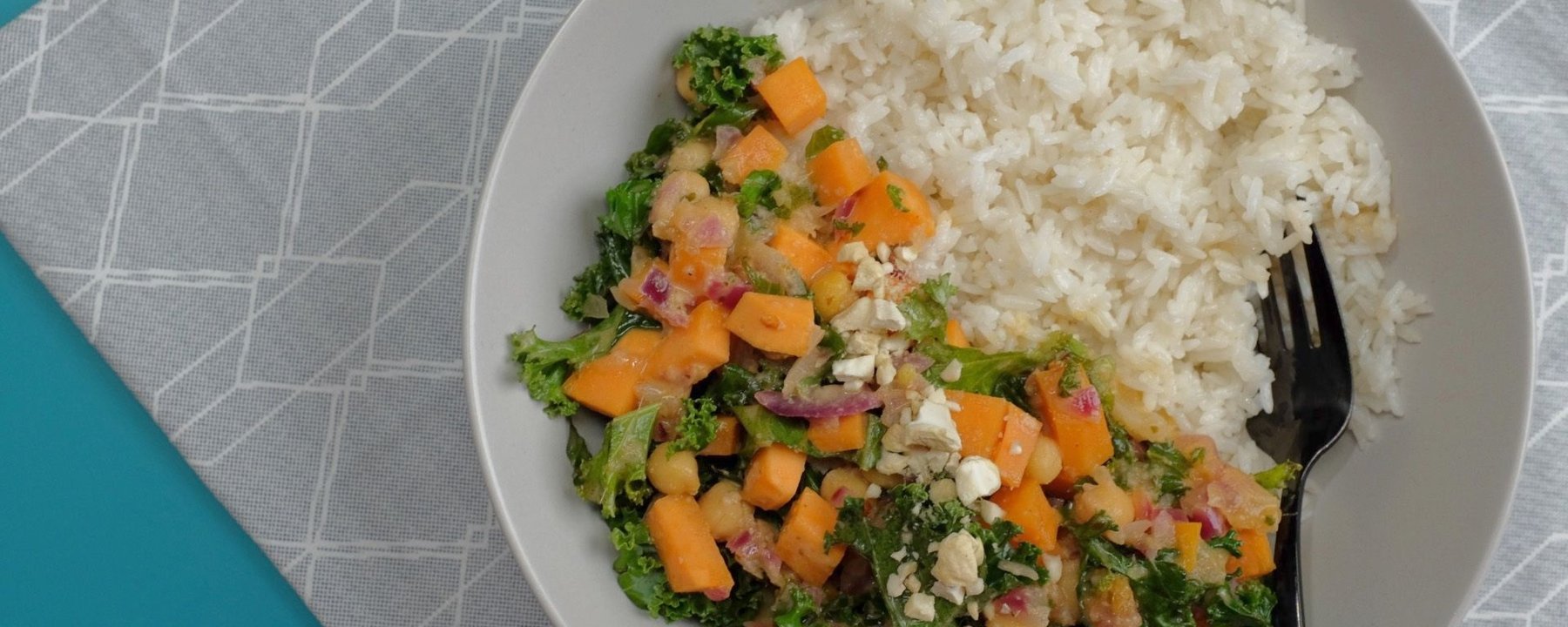 Bowl of white rice beside mixed vegetables with kale, sweet potato and chickpeas