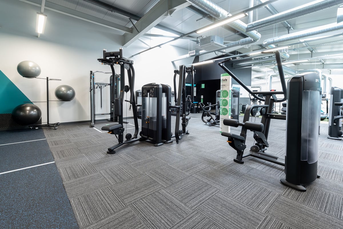 PureGym Colchester Retail Park: Weight machines, resistance bands, medicine balls, and rubberized flooring in a gym setting.