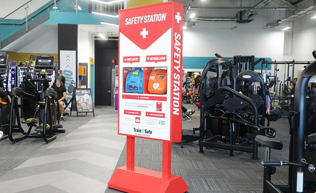 Safety station near the gym entrance with first aid kit and AED defibrillator.