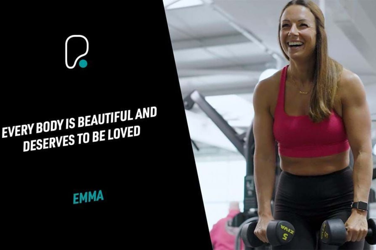 Woman in gym lifting dumbbells and smiling next to text about body positivity