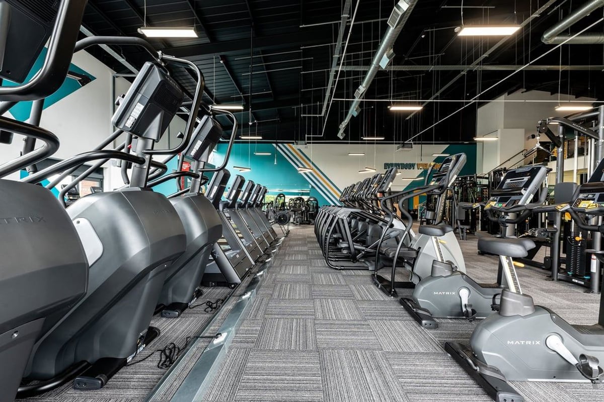 PureGym Doncaster: Rows of treadmills, ellipticals, and weight machines in a spacious gym facility.