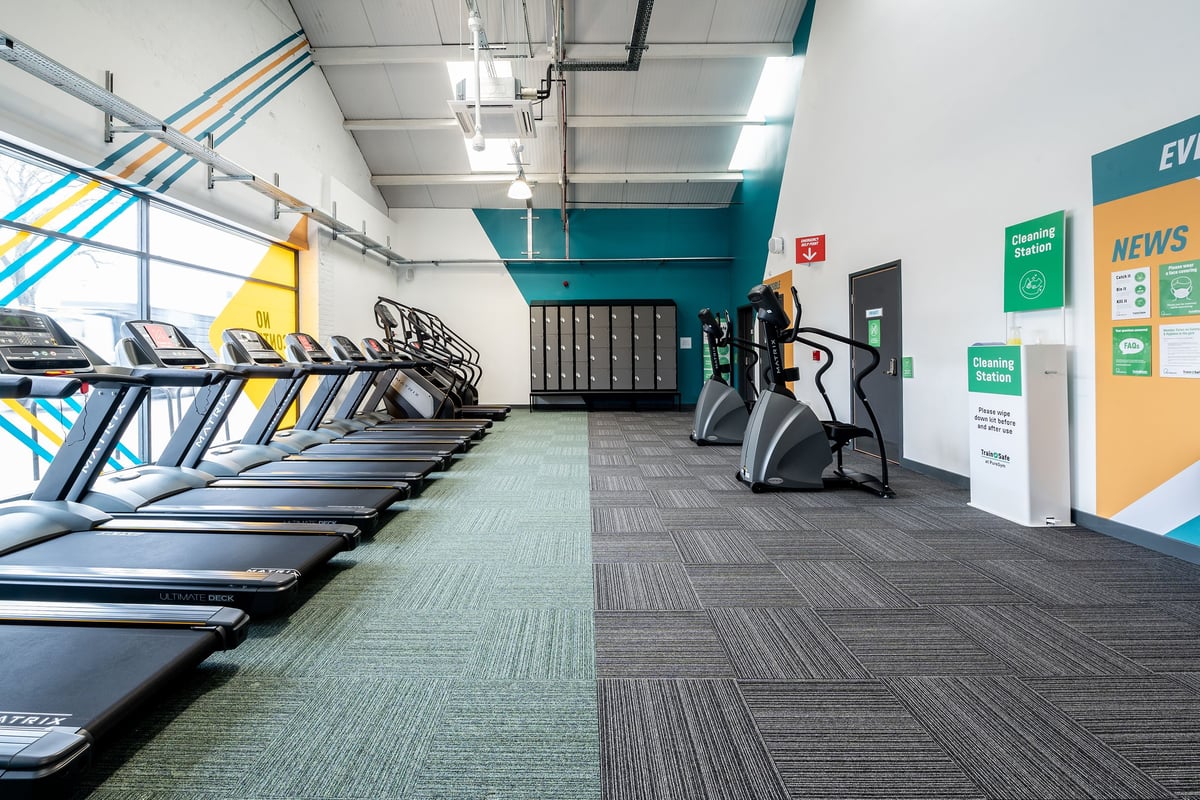 PureGym Puregym Crayford: Rows of treadmills, exercise bikes, weight machines, and signage in a gym setting.