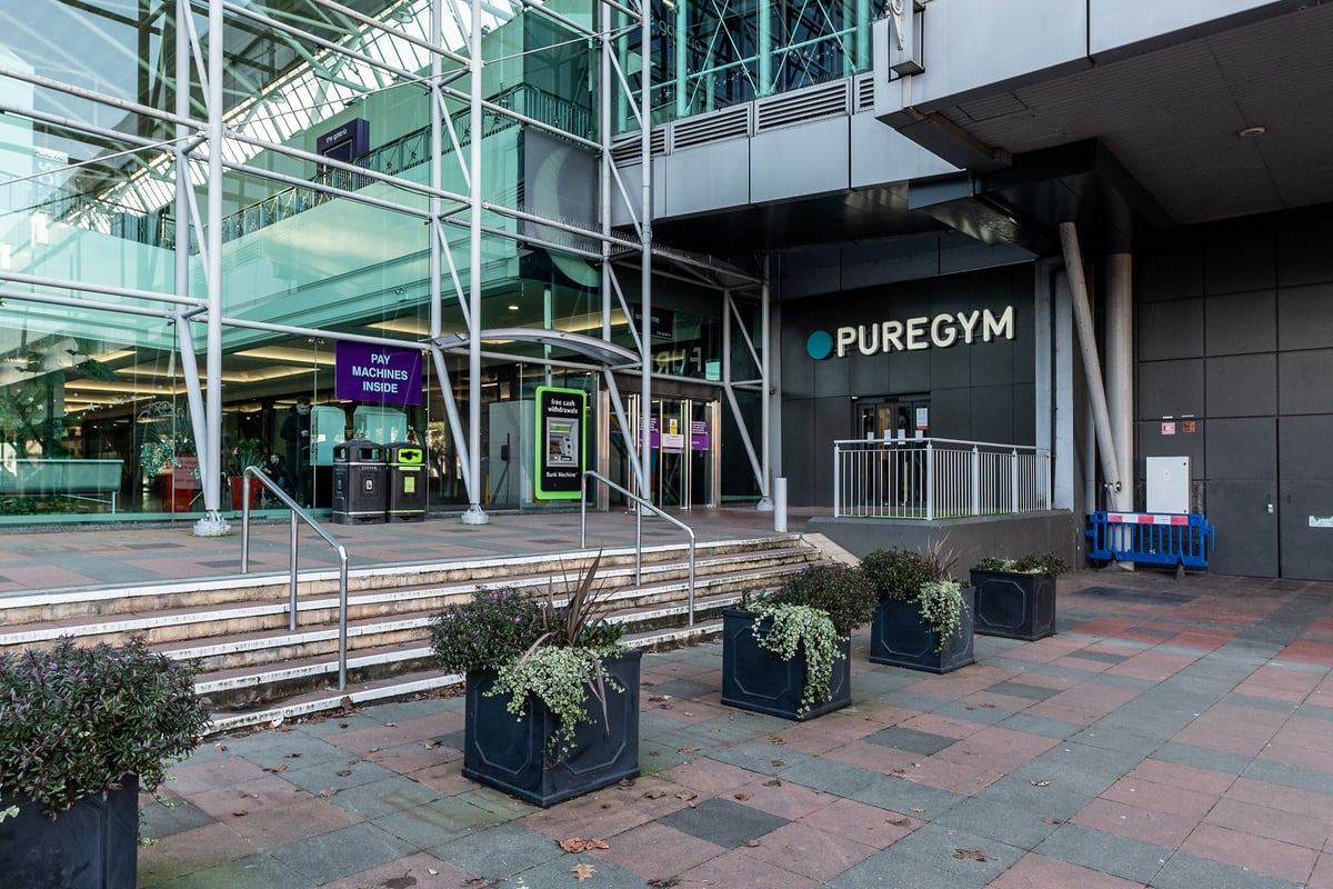 PureGym Hatfield: Exterior facade of gym with steps, landscaping, and signage.