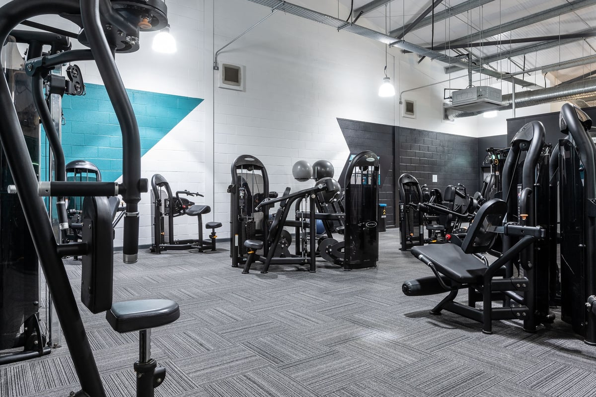 PureGym Banbury Cross Retail Park: Resistance machines, free weights, benches, and rubberized flooring in a gym studio space.