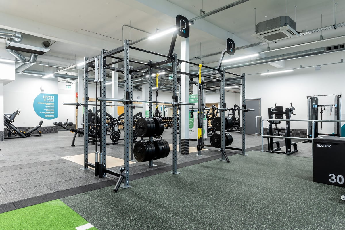 PureGym Edinburgh Craigleith Retail Park: Gym interior with rig structures, weight plates, benches, and rubberized flooring.