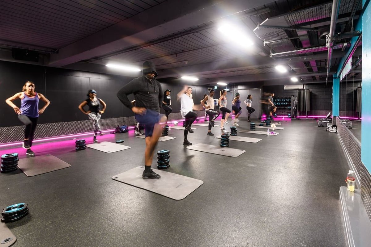 PureGym London Lambeth: Aerobic studio with step benches, free weights, and mirrored wall.