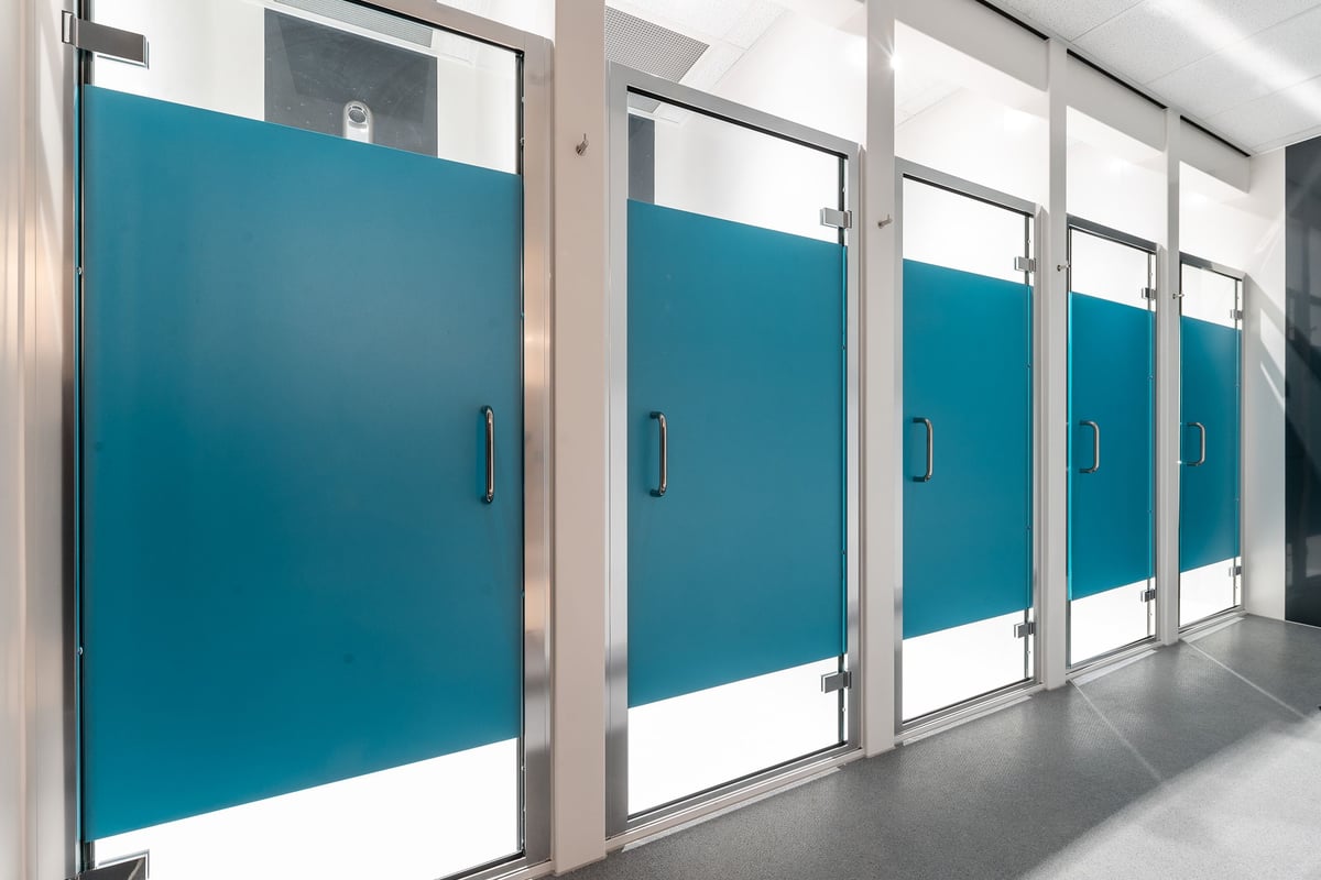 PureGym Milton Keynes Kingston Centre: Row of teal doors leading to changing rooms or showers.